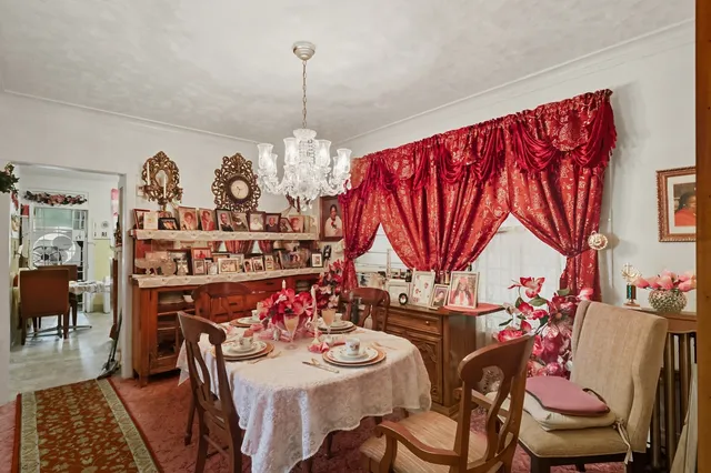 a view of a dining room with furniture and a chandelier