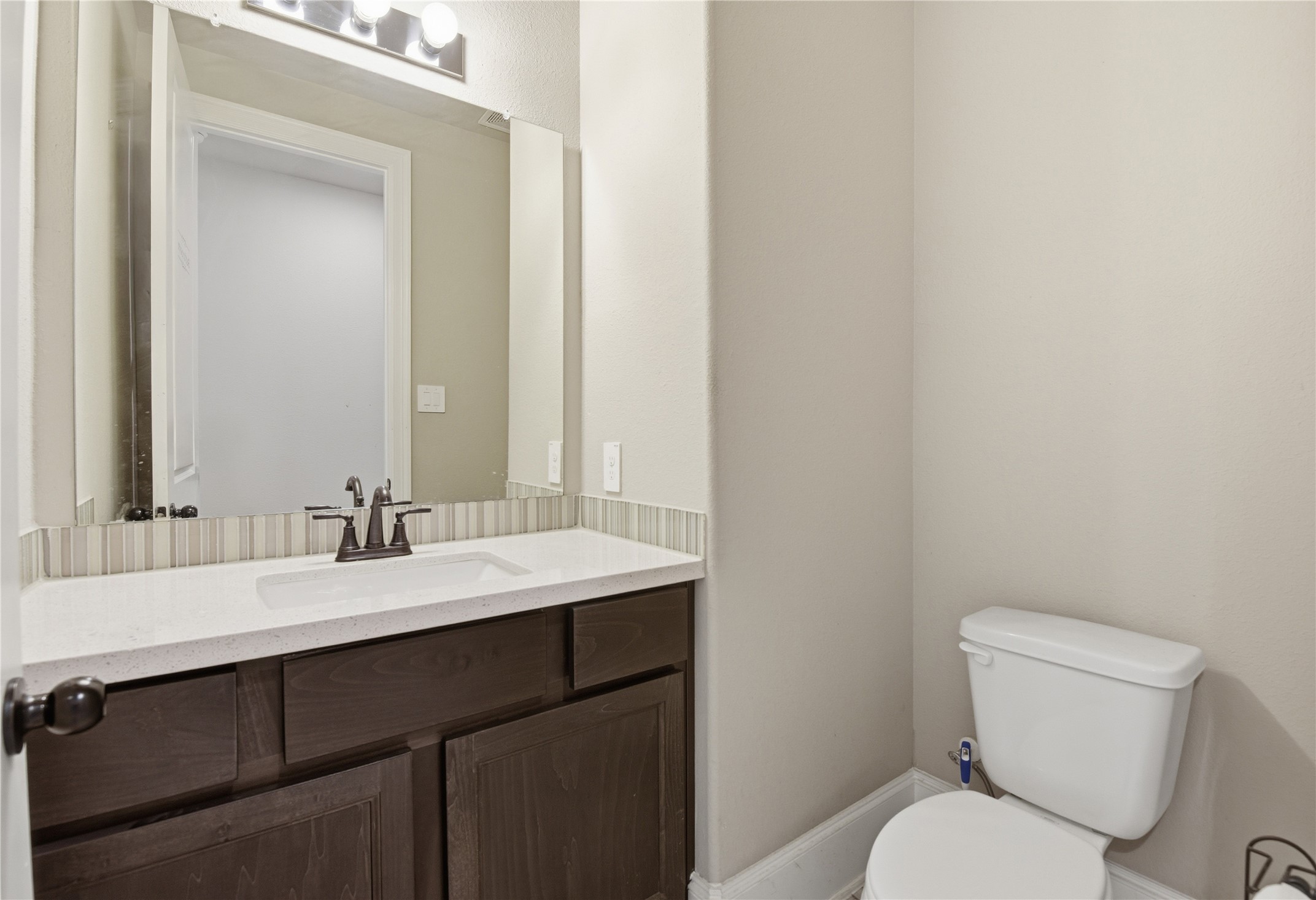 17501 Spice Merlot Lane Conroe, TX 77302 - Photo 32 of 50 a bathroom with a toilet sink and mirror