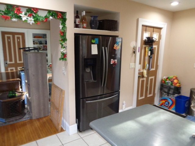 415 May Street Rockford, IL 61104 - Photo 7 of 13 a kitchen with stainless steel appliances kitchen island granite countertop a refrigerator and a sink