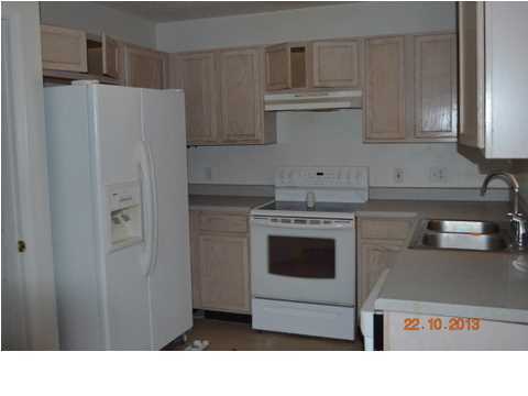 5953 Ridgecrest Road Crestview, FL 32539 - Photo 10 of 27 a kitchen with stainless steel appliances kitchen island a refrigerator sink and cabinets