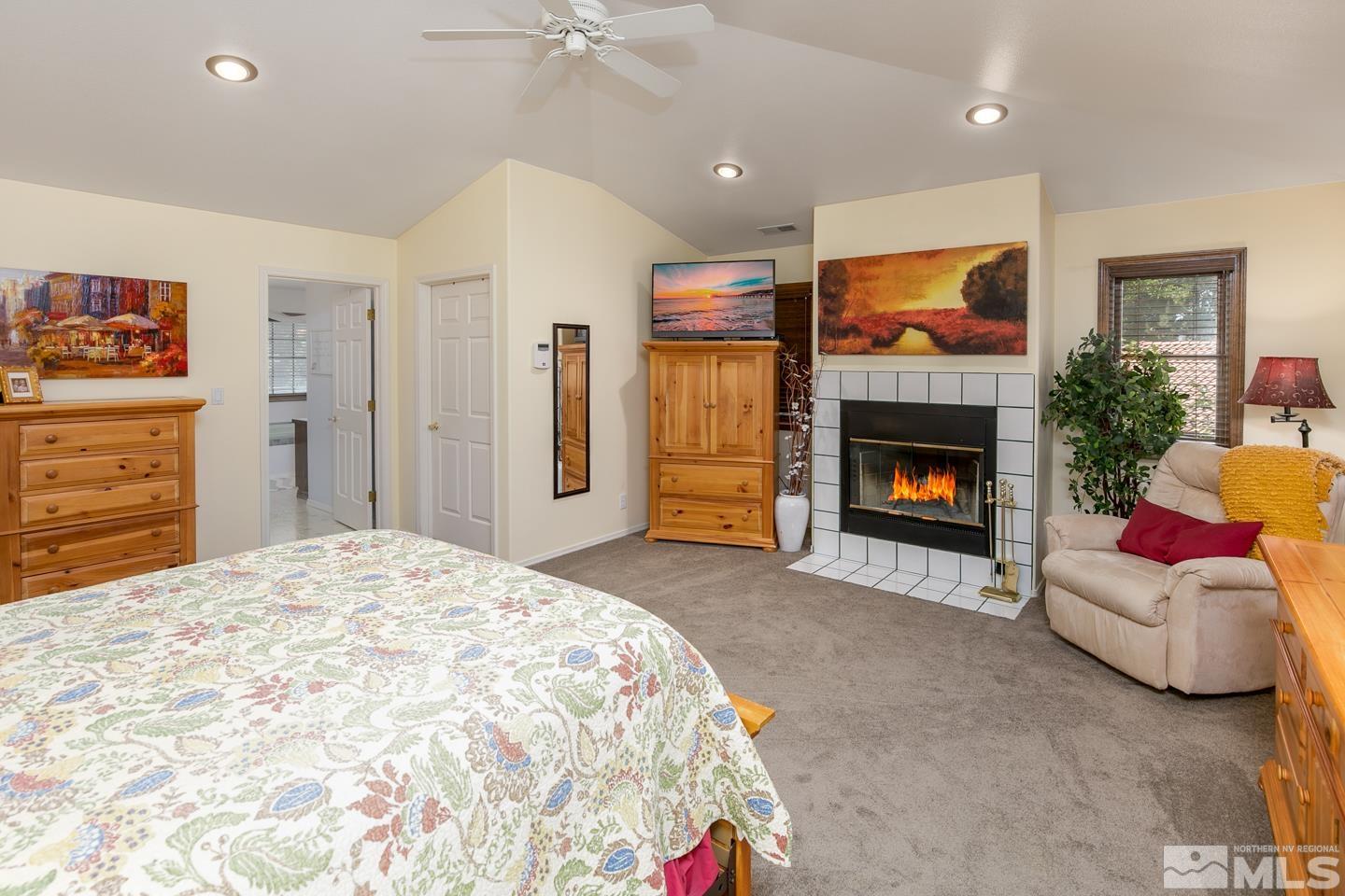 5586 Rivers Edge Drive Fallon, NV 89406 - Photo 16 of 40 a bed room with furniture and a fireplace