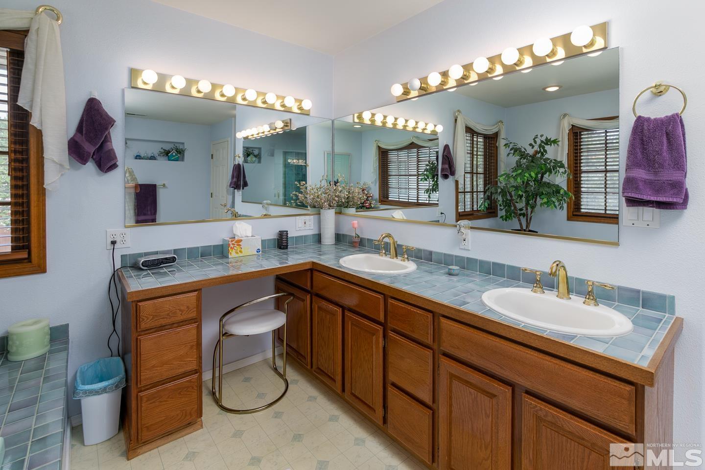 5586 Rivers Edge Drive Fallon, NV 89406 - Photo 19 of 40 a spacious bathroom with a granite countertop sink a toilet and a mirror