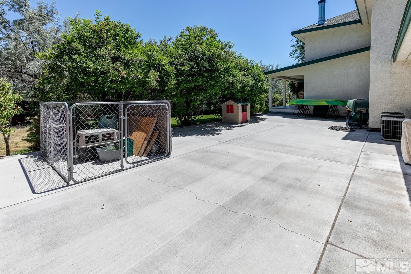 5586 Rivers Edge Drive Fallon, NV 89406 - Photo 33 of 40 a view of backyard with outdoor seating and trees in the background