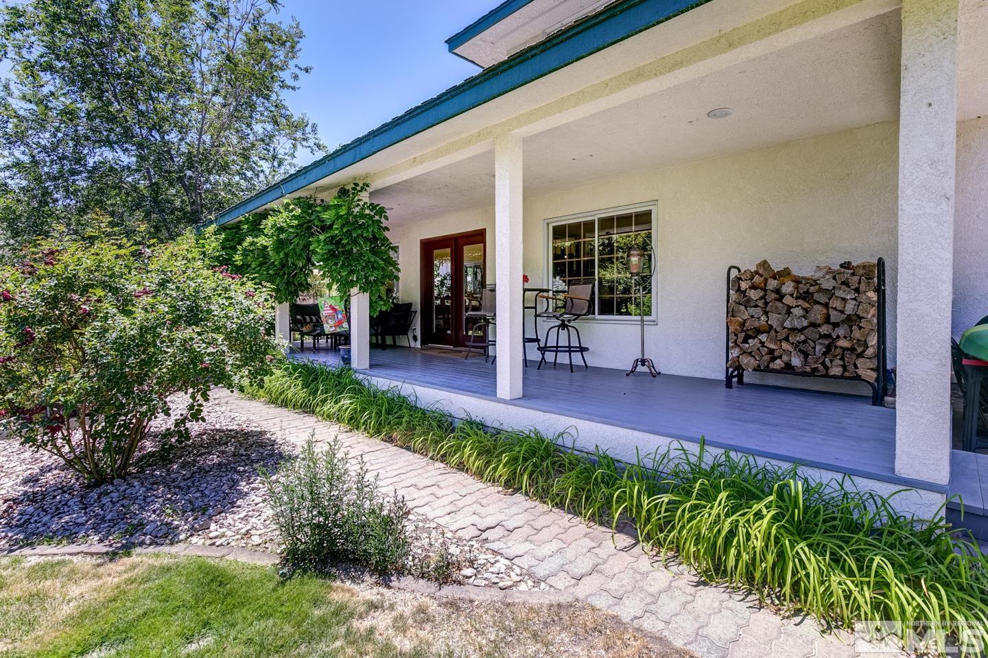 5586 Rivers Edge Drive Fallon, NV 89406 - Photo 35 of 40 a view of a patio with table and chairs and potted plants