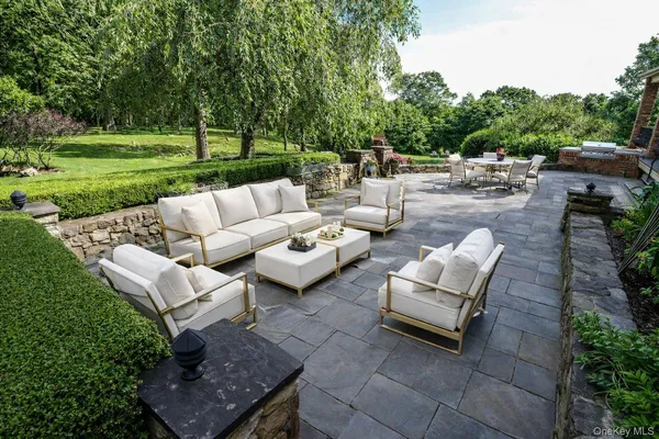 a view of a couches in a patio with a yard