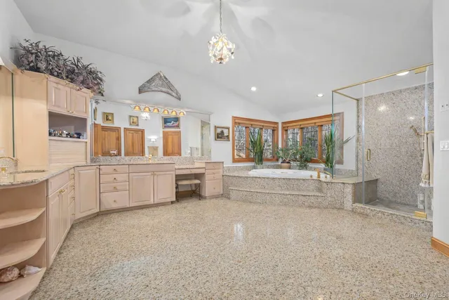 a large white bathroom with double vanity sink a bathtub and shower