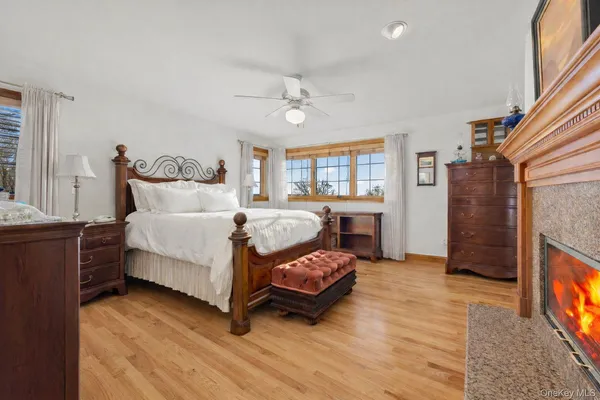a bedroom with a bed lamp and a fireplace