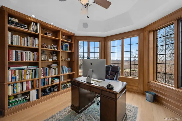 a view of a workspace with furniture and a bookshelf