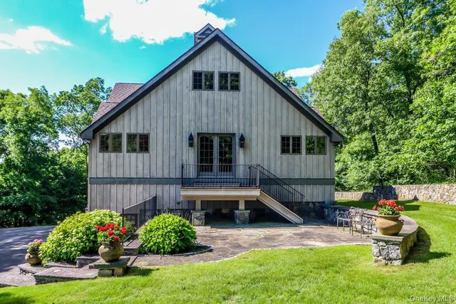 a front view of a house with a yard and outdoor seating
