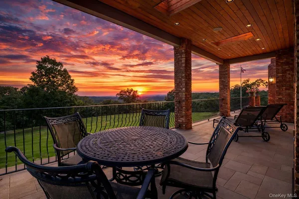 a view of a balcony with a table and chairs