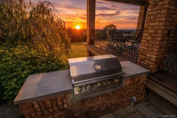 a view of a roof deck with table and chairs and wooden floor