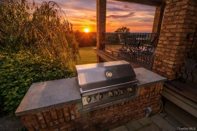 a view of a roof deck with table and chairs and wooden floor