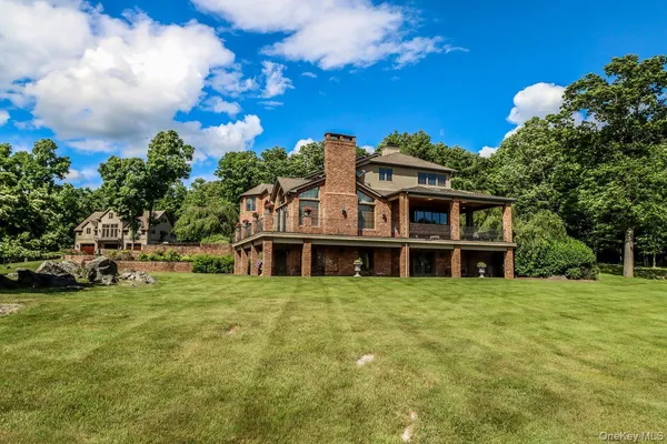 a view of a house with yard and sitting area