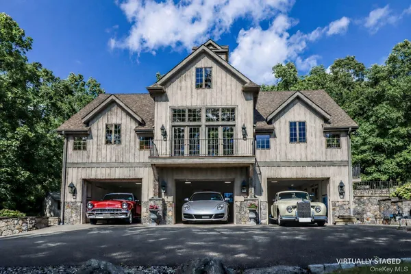 a view of a white house with a large windows and a yard