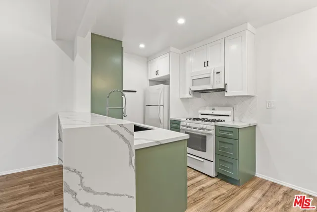 a kitchen with a sink stove and cabinets