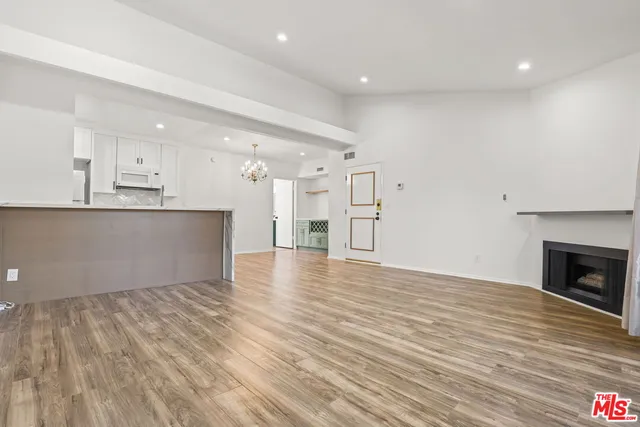 a view of kitchen and hall with wooden floor