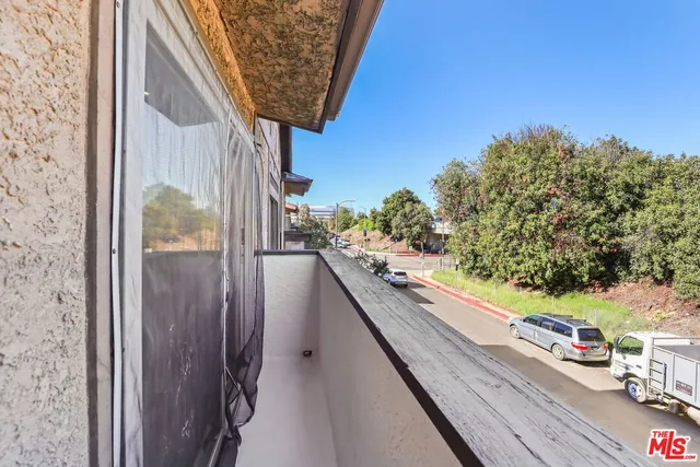 a large white kitchen with kitchen island white cabinets and stainless steel appliances