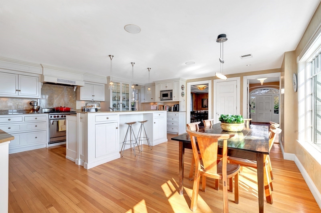 73-75 Harbor Street Manchester, MA 01944 - Photo 12 of 39 a living room with stainless steel appliances kitchen island granite countertop furniture and a kitchen view