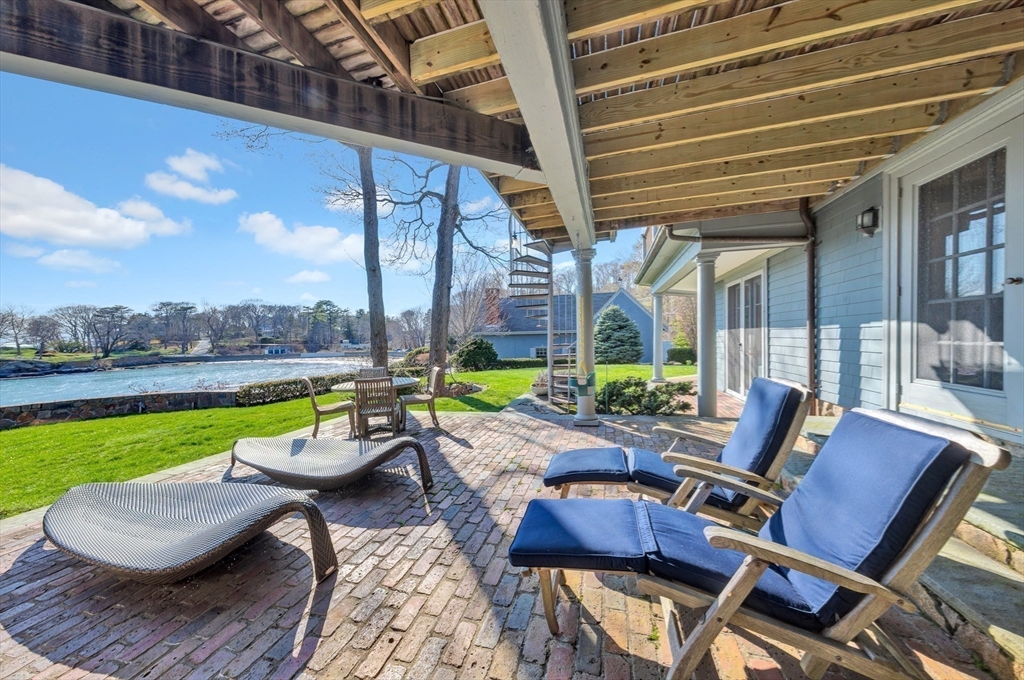 73-75 Harbor Street Manchester, MA 01944 - Photo 28 of 39 a view of a patio with lawn chairs wooden floor and floor to ceiling window yard