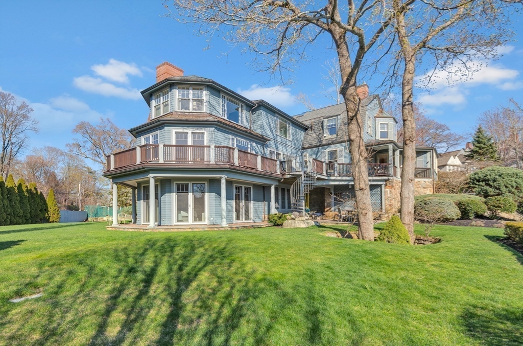 73-75 Harbor Street Manchester, MA 01944 - Photo 32 of 39 a front view of a house with a garden and trees