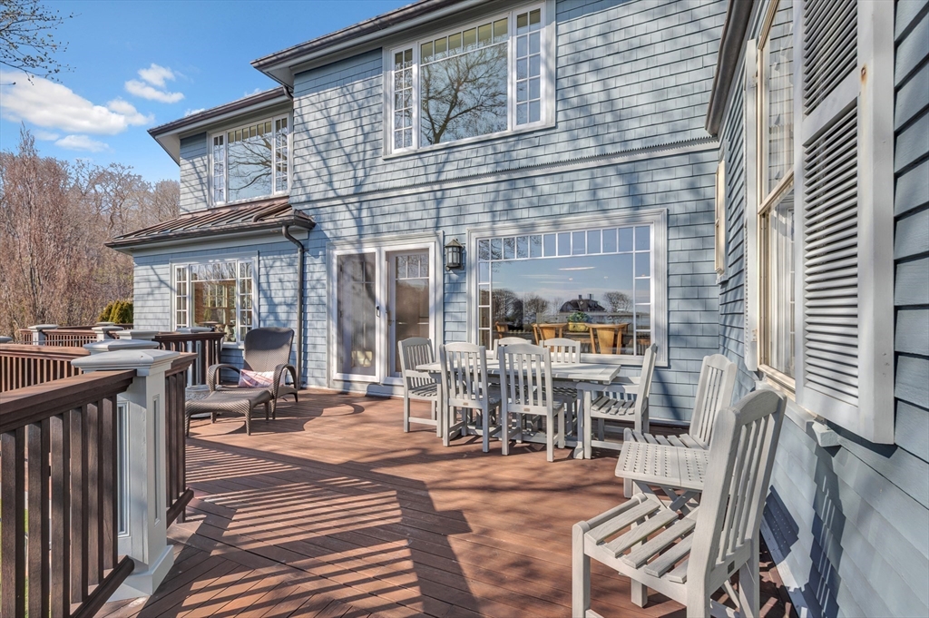 73-75 Harbor Street Manchester, MA 01944 - Photo 10 of 39 a view of a patio with table and chairs and wooden floor