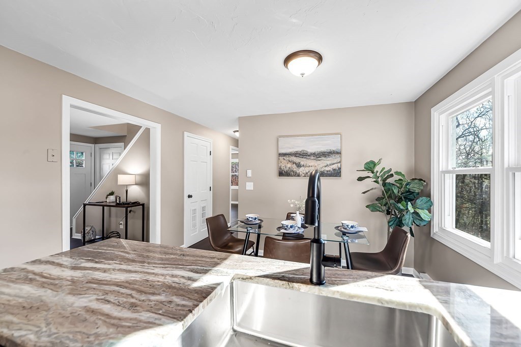 9 Hillside Road Leicester, MA 01611 - Photo 12 of 42 a dining room with kitchen island granite countertop a sink table and chairs