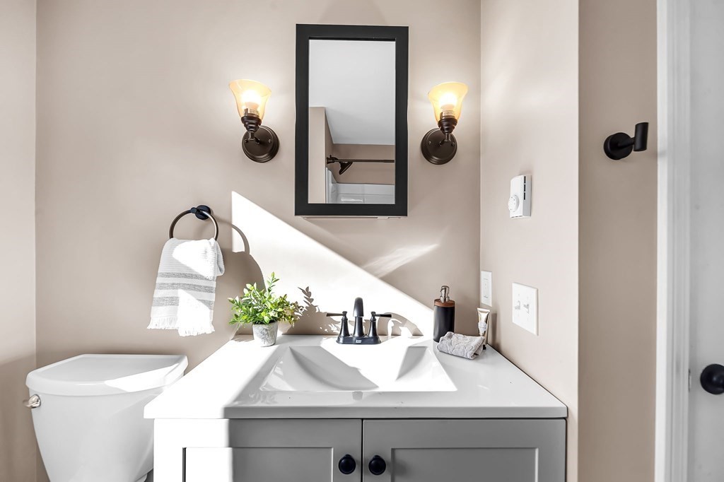 9 Hillside Road Leicester, MA 01611 - Photo 16 of 42 a bathroom with a sink and mirror with toilet