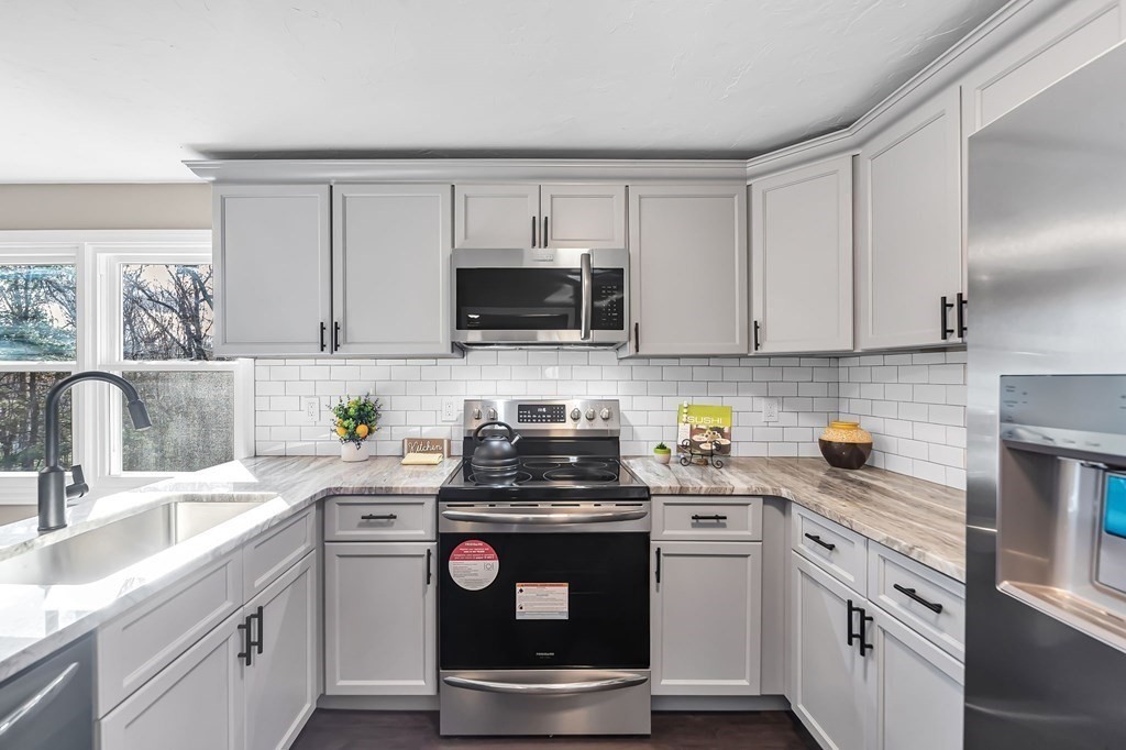 9 Hillside Road Leicester, MA 01611 - Photo 6 of 42 a kitchen with a sink stove and microwave