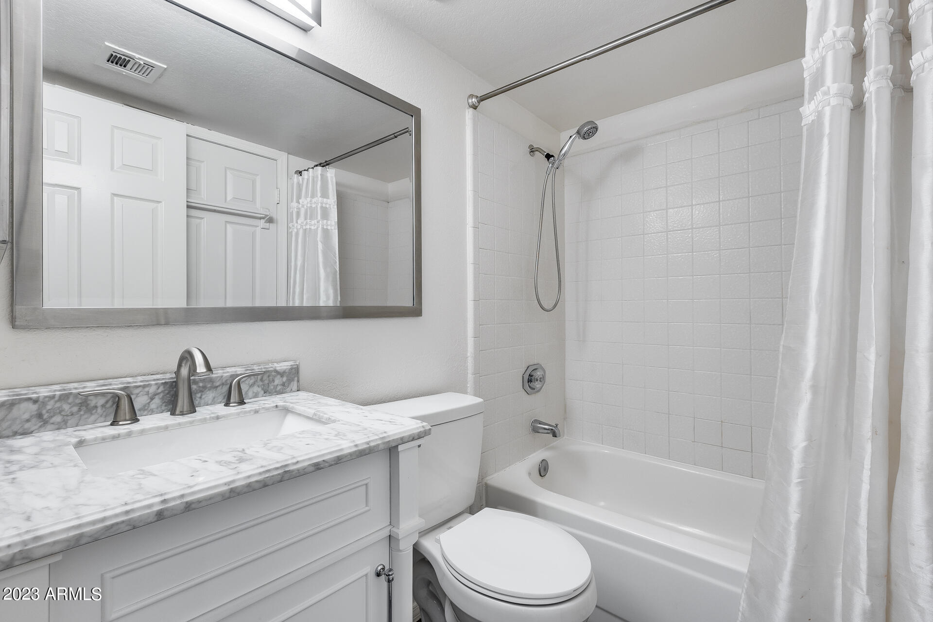 170 East Guadalupe Road, Unit 77 Gilbert, AZ 85234 - Photo 18 of 31 a bathroom with a granite countertop sink a toilet and shower