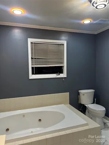 a view of a house with a wooden fence