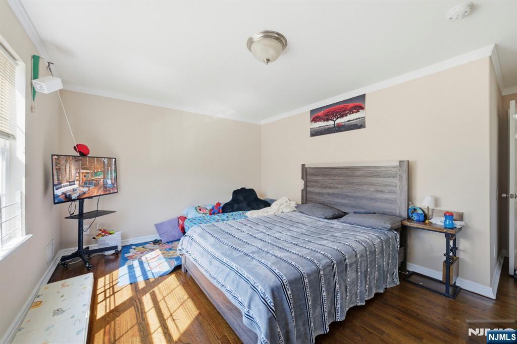 56 Lentz Avenue Newark, NJ 07105 - Photo 12 of 50 a bedroom with a bed and a table in it