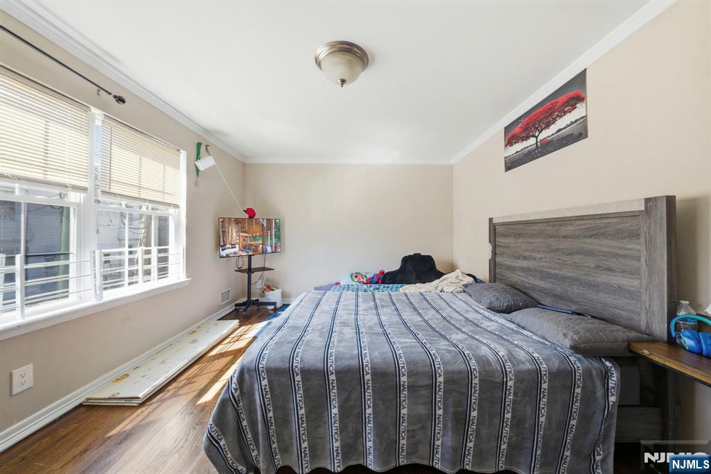 56 Lentz Avenue Newark, NJ 07105 - Photo 27 of 50 a bedroom with a bed and a window