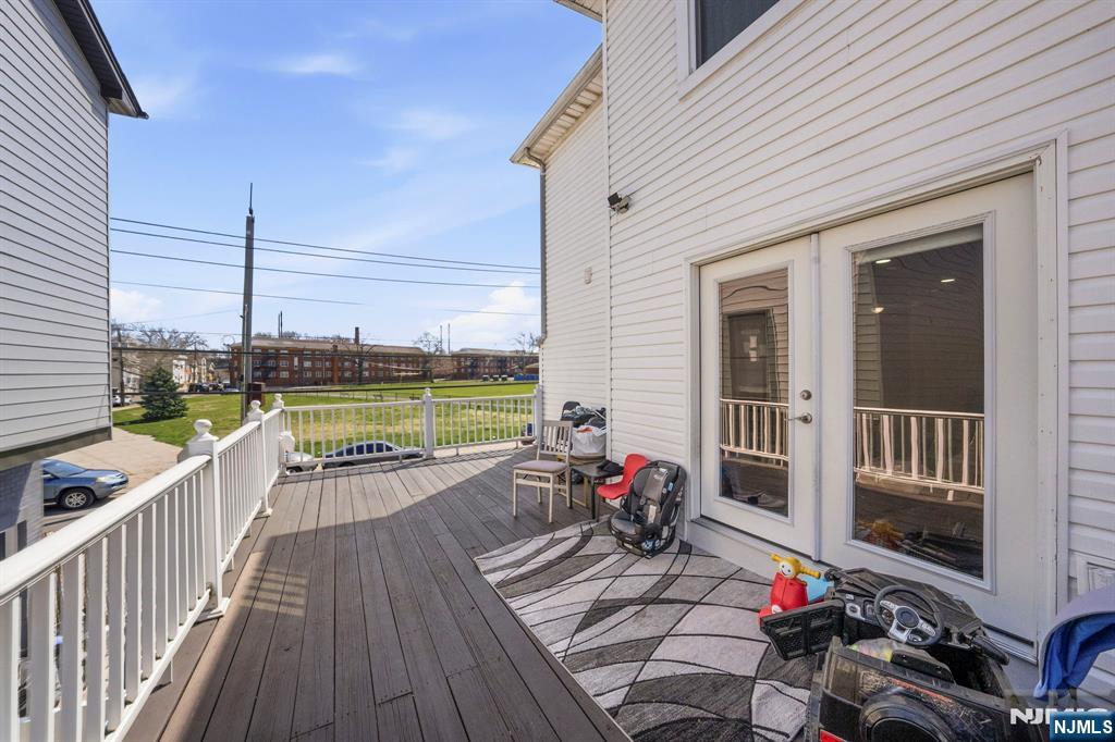 56 Lentz Avenue Newark, NJ 07105 - Photo 29 of 50 a view of a balcony with couch and wooden floor