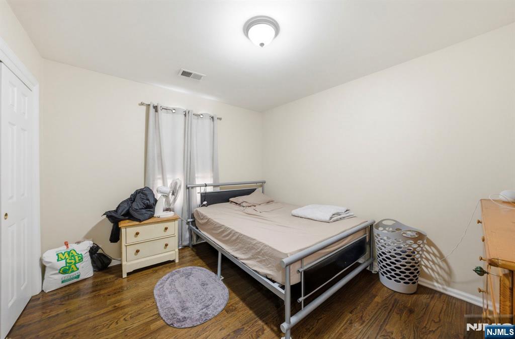 56 Lentz Avenue Newark, NJ 07105 - Photo 32 of 50 a bedroom with a bed and wooden floor