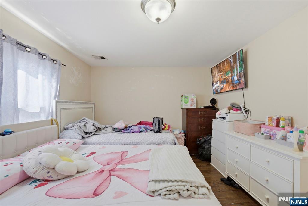 56 Lentz Avenue Newark, NJ 07105 - Photo 36 of 50 a bedroom with a bed and dresser
