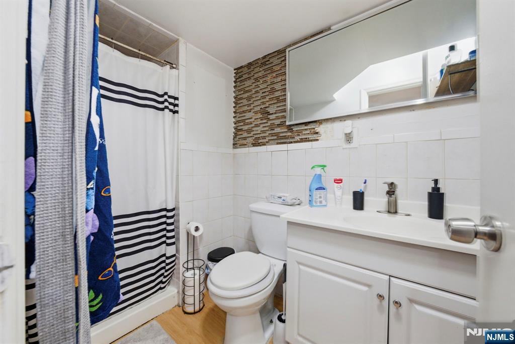 56 Lentz Avenue Newark, NJ 07105 - Photo 41 of 50 a bathroom with a sink a toilet and a mirror