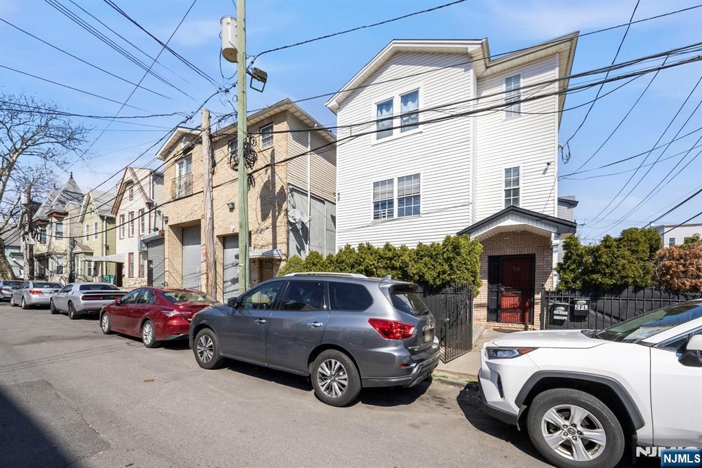 56 Lentz Avenue Newark, NJ 07105 - Photo 5 of 50 a front view of a house with cars parked