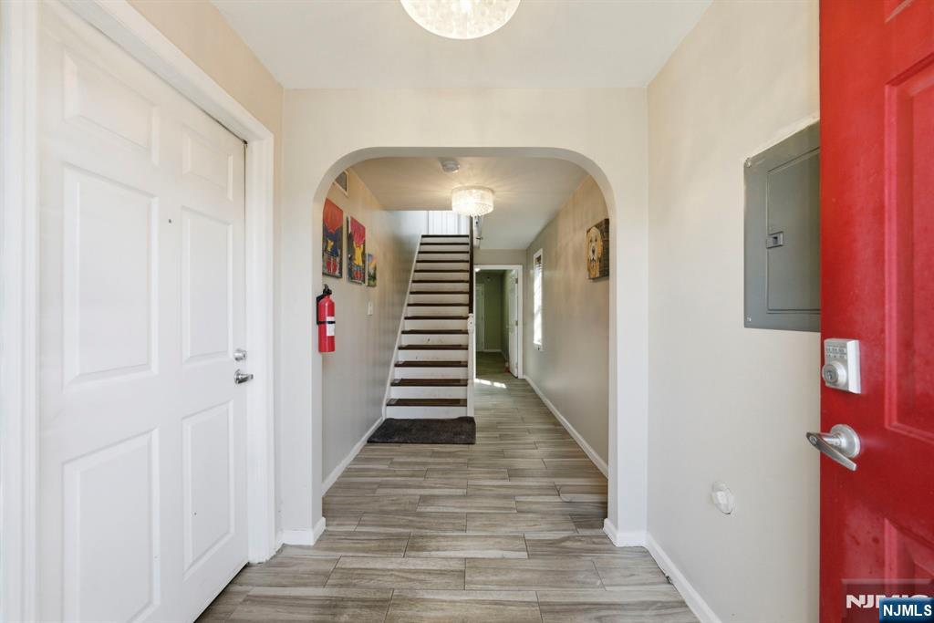 56 Lentz Avenue Newark, NJ 07105 - Photo 9 of 50 a view of a hallway with wooden floor and stairs