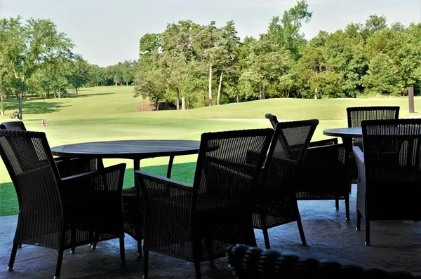 a view of a swimming pool with an outdoor space and seating area