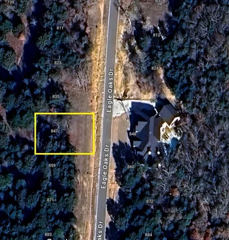 a view of a backyard of a house with a lake view