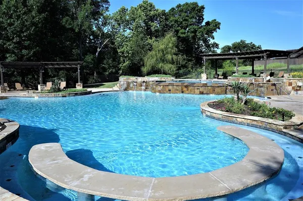 a view of a patio with swimming pool table and chairs