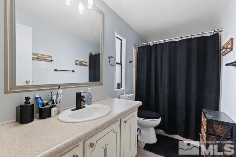 3885 Puffin Street Reno, NV 89508 - Photo 11 of 18 a bathroom with a sink and a mirror