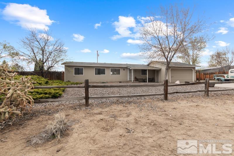 3885 Puffin Street Reno, NV 89508 - Photo 2 of 18 a white house with a large tree in front of it