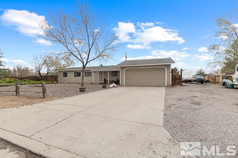 3885 Puffin Street Reno, NV 89508 - Photo 3 of 18 a front view of a house with a yard and garage