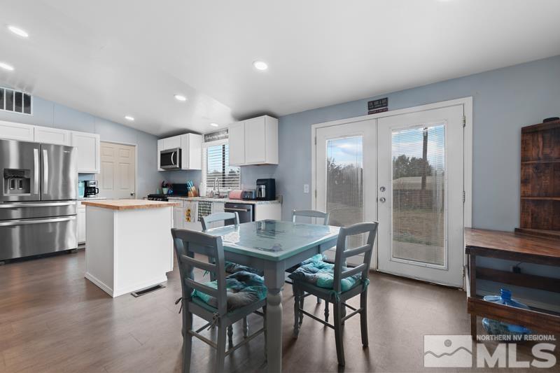 3885 Puffin Street Reno, NV 89508 - Photo 7 of 18 a kitchen with a table chairs refrigerator and cabinets