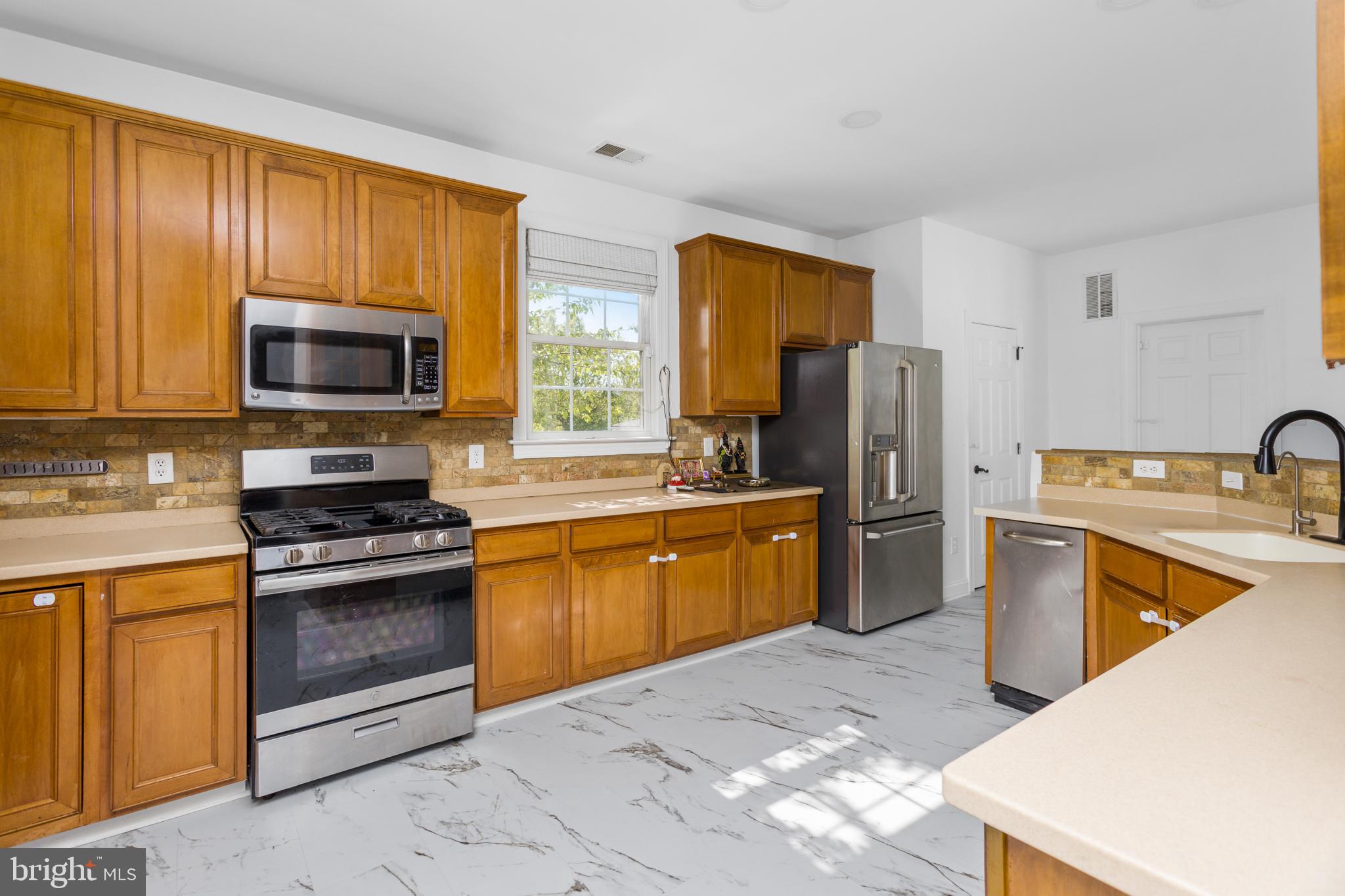 6 Hulse Street Robbinsville, NJ 08691 - Photo 21 of 75 a kitchen with stainless steel appliances granite countertop a stove refrigerator sink and microwave