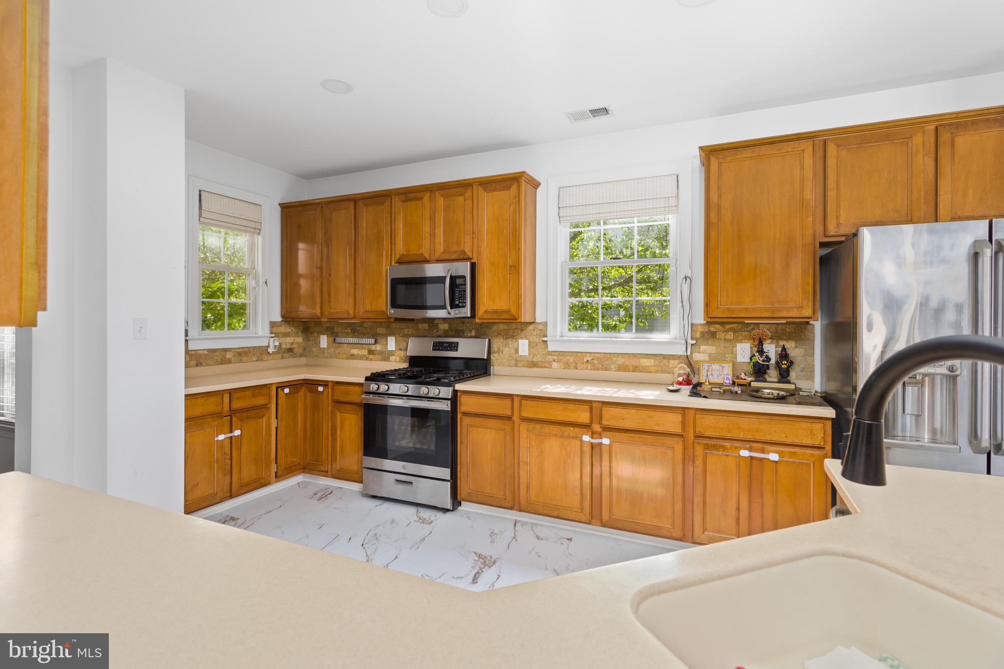 6 Hulse Street Robbinsville, NJ 08691 - Photo 23 of 75 a kitchen with stainless steel appliances granite countertop a sink a stove a refrigerator with grey cabinets