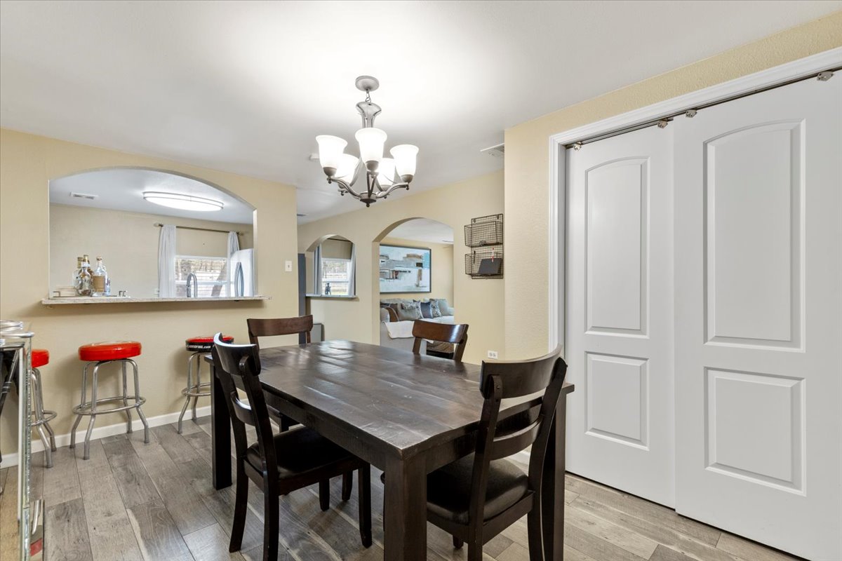 240 Riddle Road Cedar Creek, TX 78612 - Photo 11 of 31 a view of a dining room with furniture and wooden floor