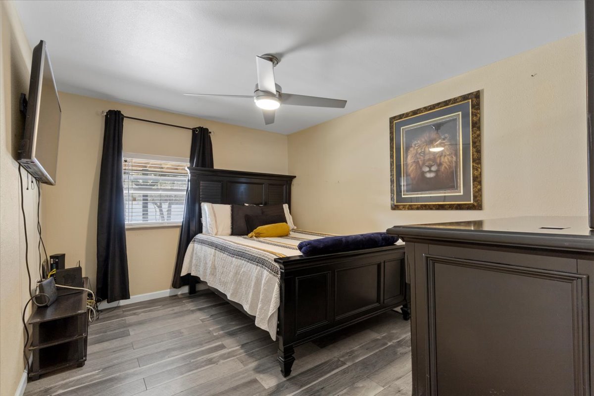 240 Riddle Road Cedar Creek, TX 78612 - Photo 17 of 31 a bedroom with a bed and a flat tv screen on the dresser
