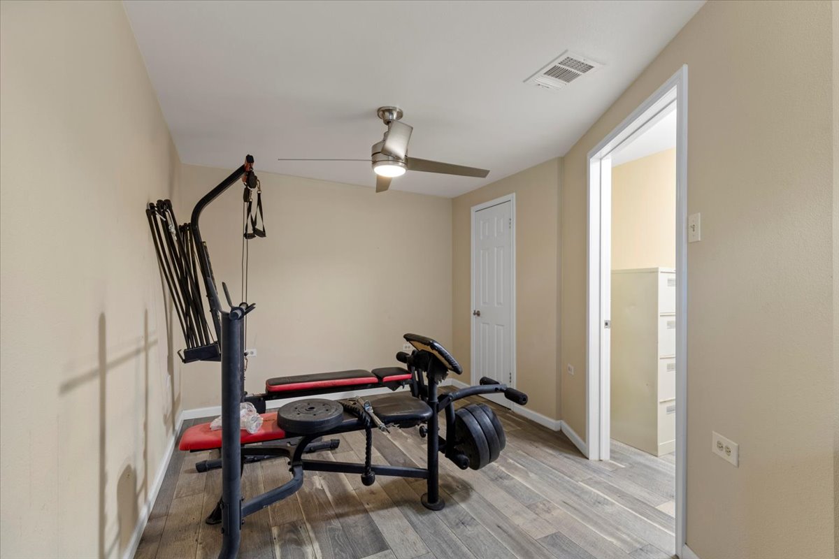 240 Riddle Road Cedar Creek, TX 78612 - Photo 19 of 31 a room with furniture and wooden floor